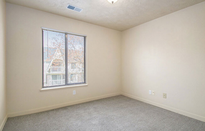 bedroom with a large window and carpeting at Old Farm Apartments, Elkhart, Indiana