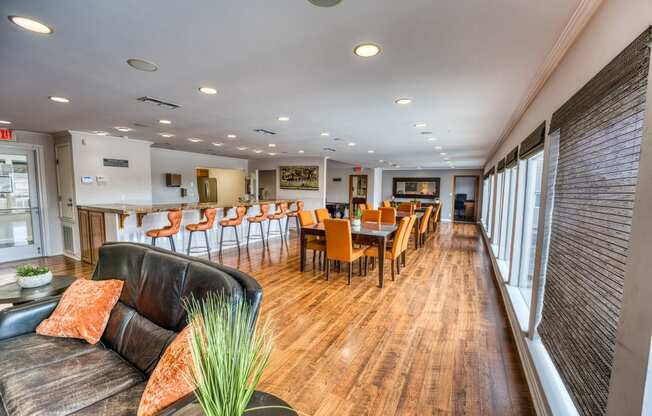 a living room with a table and chairs and a bar