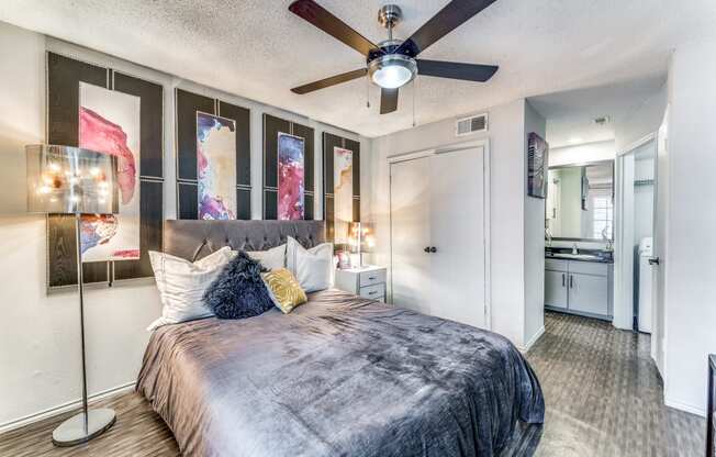 a bedroom with a large bed and a ceiling fan