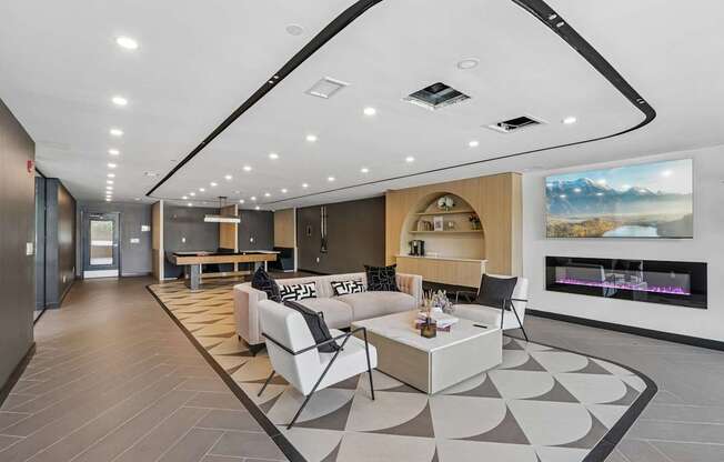 A modern living room with a fireplace and a large painting on the wall.