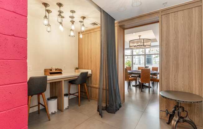 a dining area with a table and chairs and a doorway to a dining room