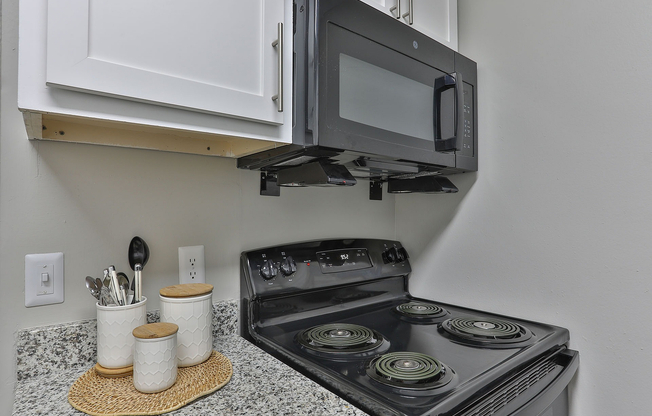 Kitchen with granite counters and black appliances