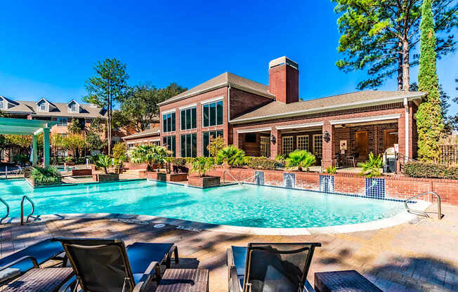 A pool with chairs and a building in the background.