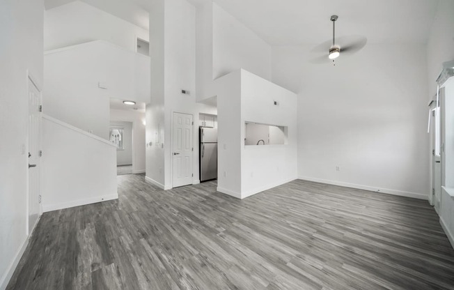 a bedroom with hardwood floors and white walls