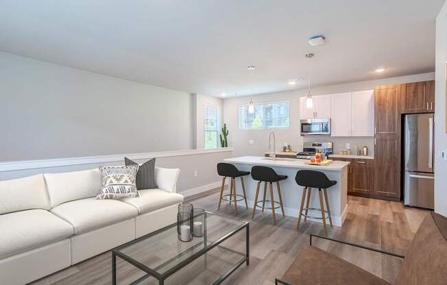 A modern kitchen with white cabinets and a breakfast bar.