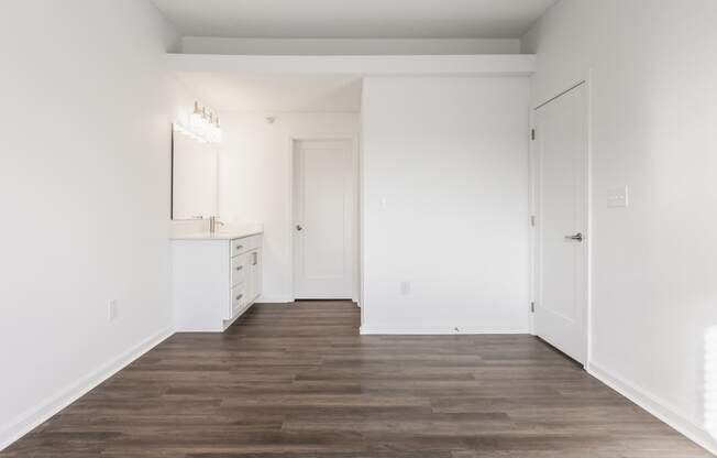 an empty bedroom with white walls and wood flooring in Greenwood