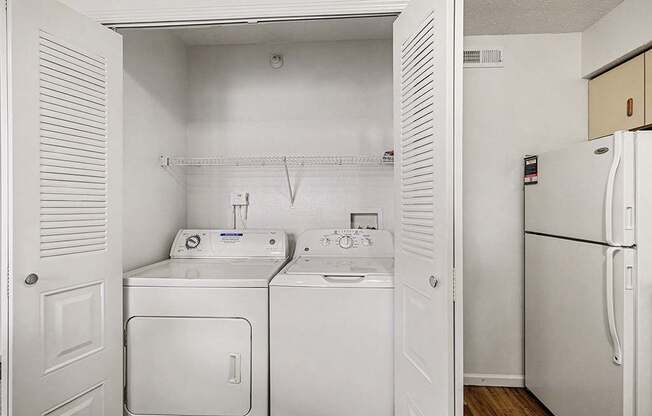 A laundry area with a washer and dryer  at West Hampton Park Apartment Homes, Nebraska, 68022