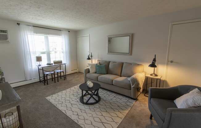 This is a photo of the living room in the 740 square foot 1 bedroom model apartment at Compton Lake Apartments in Mt. Healthy, OH.