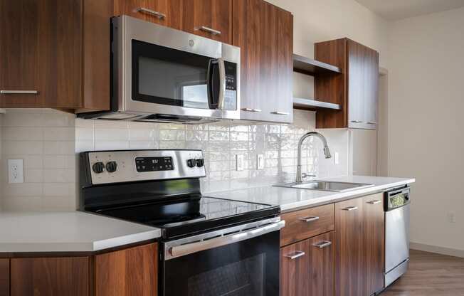 a kitchen with a stove microwave and sink