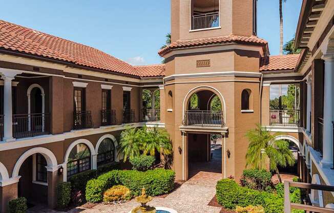 Central tower and fountain courtyard creating a grand entrance at Magnolia Carillon Apartments.
