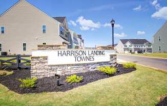 the sign at the entrance landing townships with houses in the background