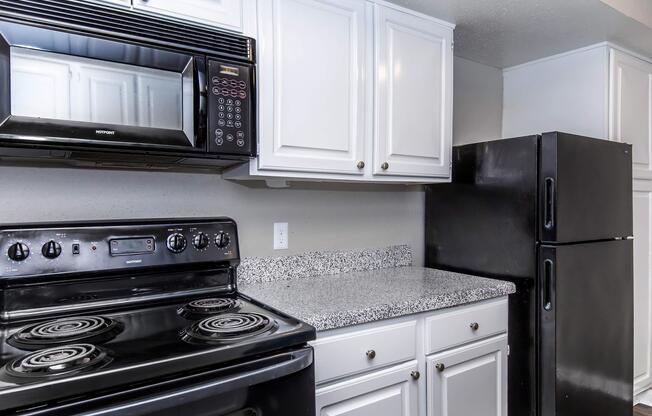 a stove top oven sitting inside of a kitchen