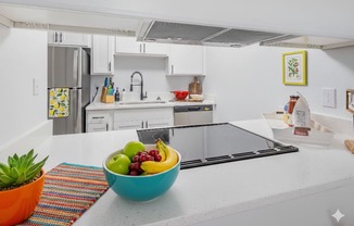 A bowl of fruit sits on a kitchen counter.