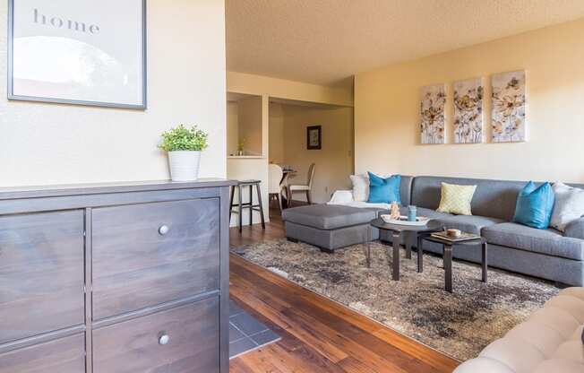 Enclave living room with cozy couches and wood-like flooring