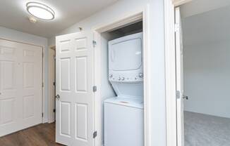 an empty laundry room with a washer and dryer
