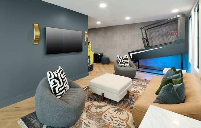 A modern living room with a grey ottoman and a white bench.