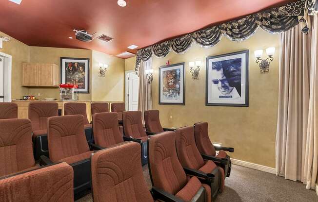 A row of red seats in a movie theater.