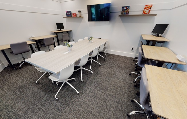 View of Semi-Private Coworking space with adjustable desks at Apt CoWork at The Marq Highland Park