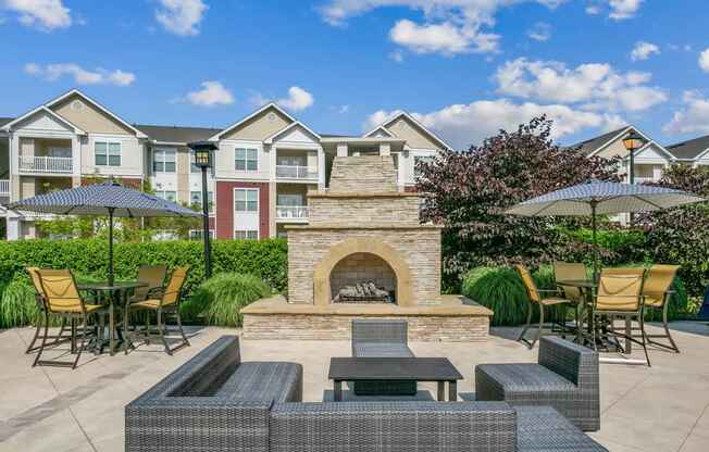 A patio with a fireplace and seating area.at Century Hampton Roads, Suffolk, 23435  