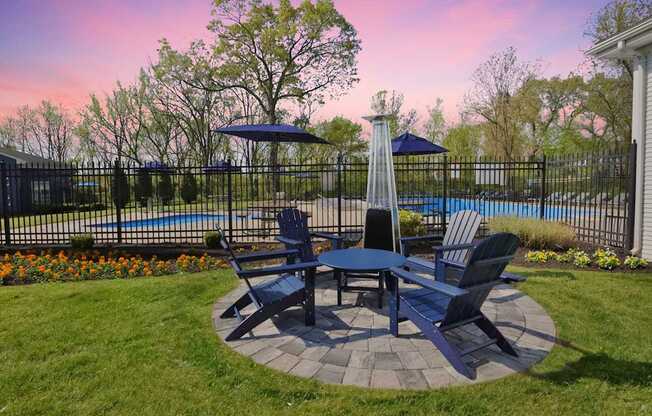 A backyard with a table and chairs set up for outdoor dining.
