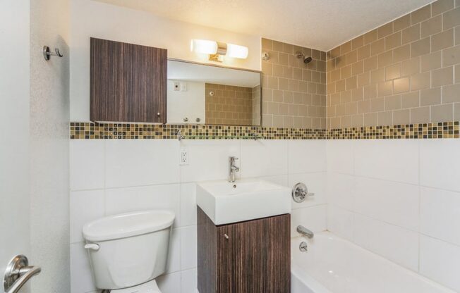 Bathroom with tiled walls and vanity storage