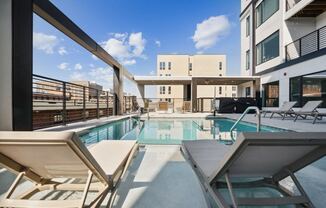the pool area of a building with a swimming pool and lounge chairs  at The Box, Virginia, 23224