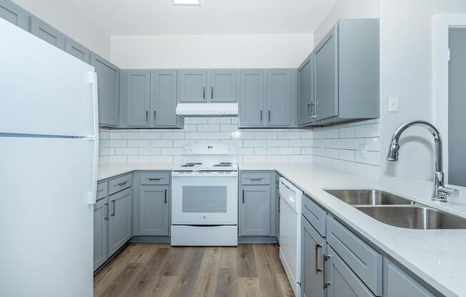 a kitchen with a stove sink and refrigerator