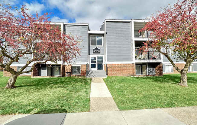 our apartments feature a spacious courtyard with trees and grass