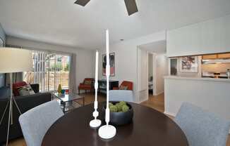 a living room and dining room with a table and chairs