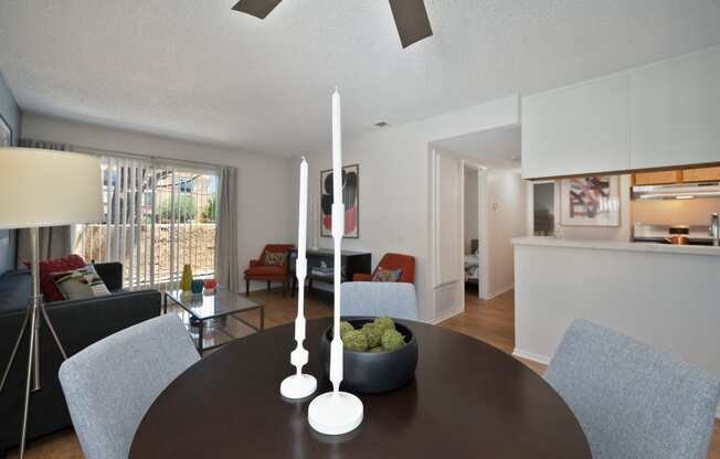 a living room and dining room with a table and chairs