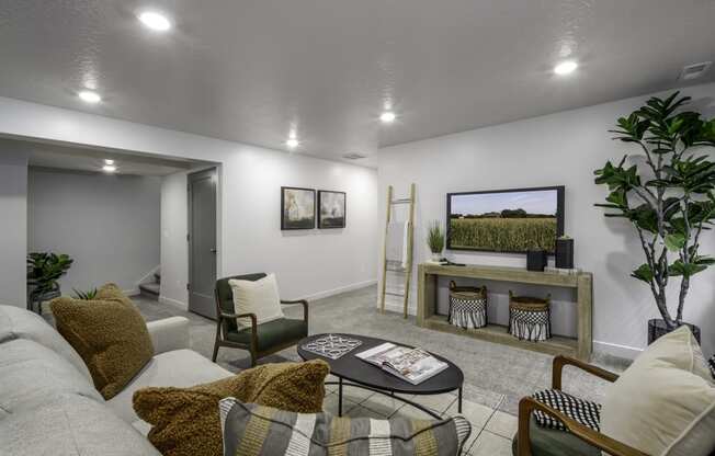 a living room with a couch and a coffee table and a television