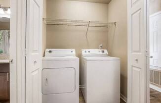 a washer and dryer in a laundry room with a closet