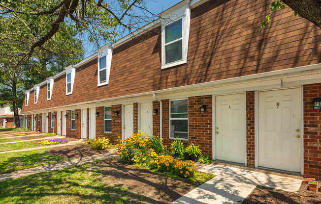A row of houses with white doors and windows.