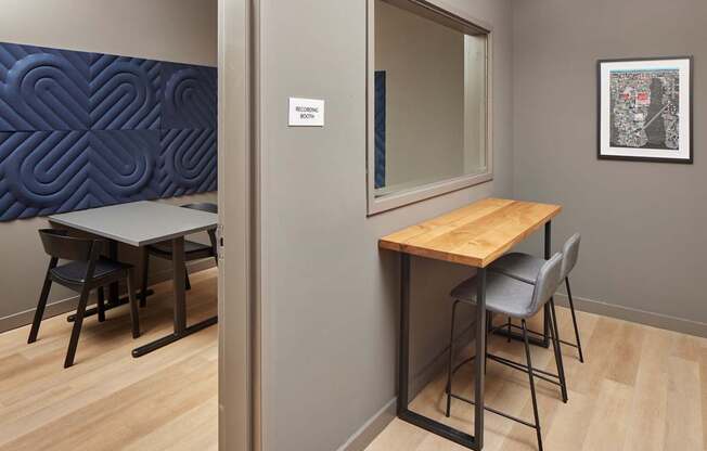 A conference room with a wooden table and chairs.