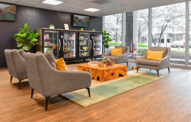 A waiting room with chairs and a table.