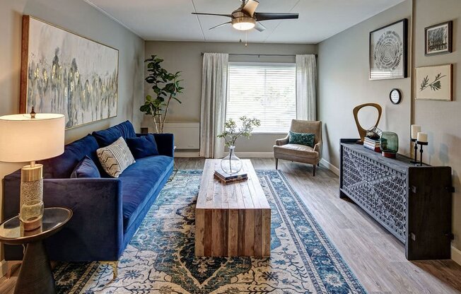 a living room with a blue couch and a coffee table