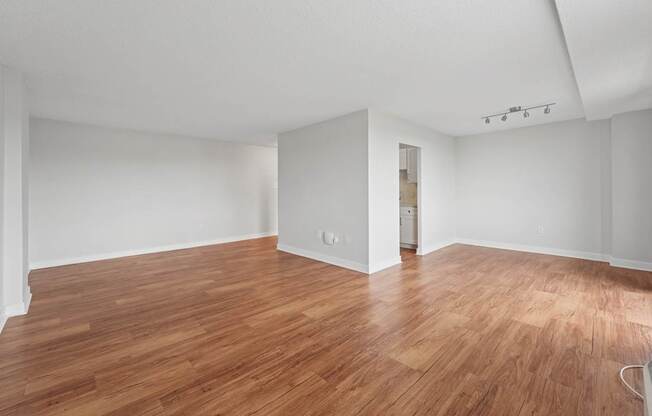 A room with wooden flooring and white walls  at Riverside Apartments, Alexandria, Virginia