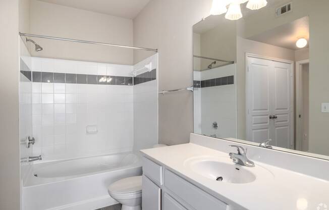 a bathroom with a sink and a bath tub and a mirror