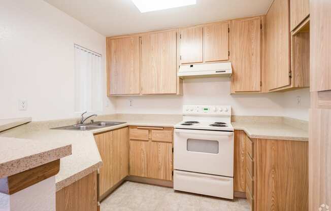 a kitchen with wooden cabinets and white appliances