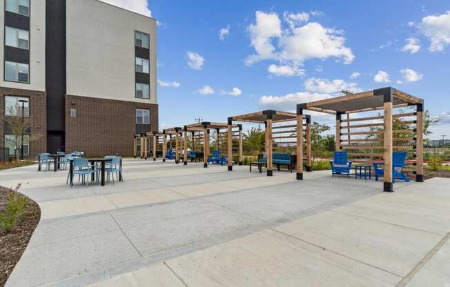 a patio with tables and chairs outside of a building