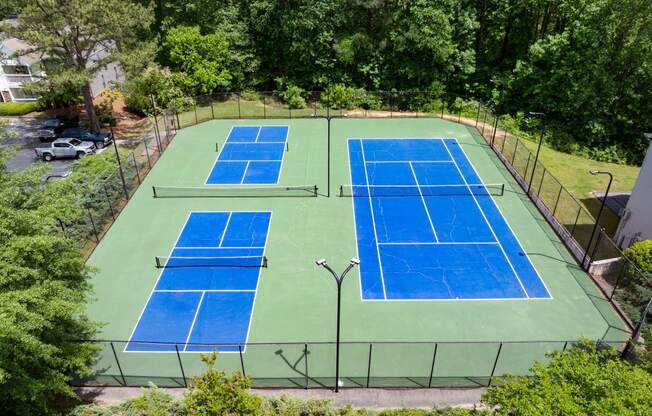 an aerial view of a tennis court with two blue tennis