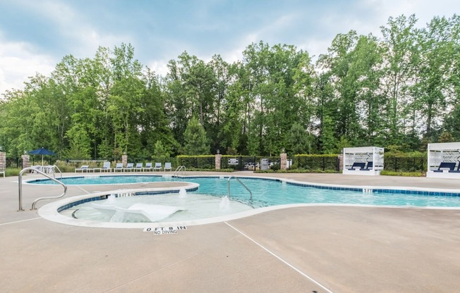 the swimming pool at oakdale apartments has a pool and hot tub