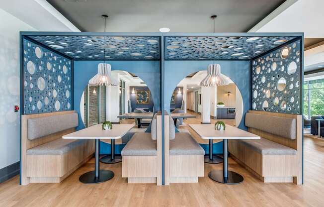 a restaurant with blue walls and tables and chairs