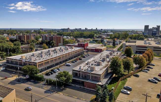 an aerial view of a parking lot and buildings in a city at The Lofts at Elk Terminal, Buffalo, NY