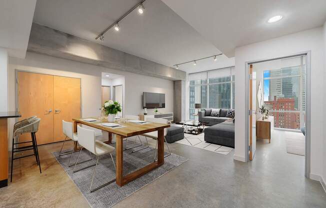 A modern kitchen with a dining table and chairs is shown.