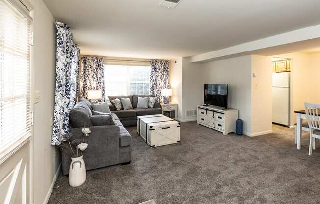 a living room with grey carpet and a grey couch at Chapel Valley Townhomes, Baltimore, 21236