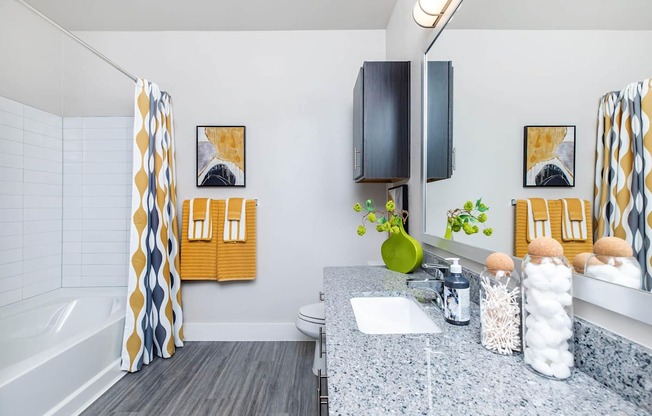 A bathroom with a grey floor and a white sink.