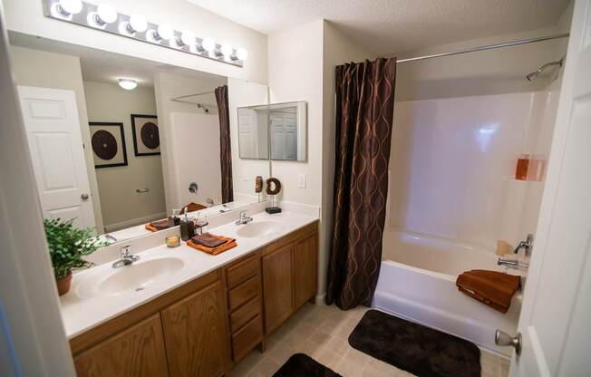 A bathroom with a brown and white theme.