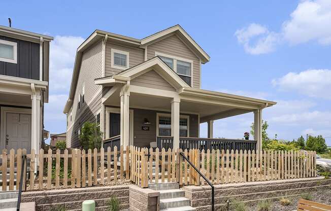 a house with a wooden fence in front of it