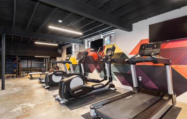 a gym with treadmills and other exercise equipment at Renew Madison, Madison, Wisconsin